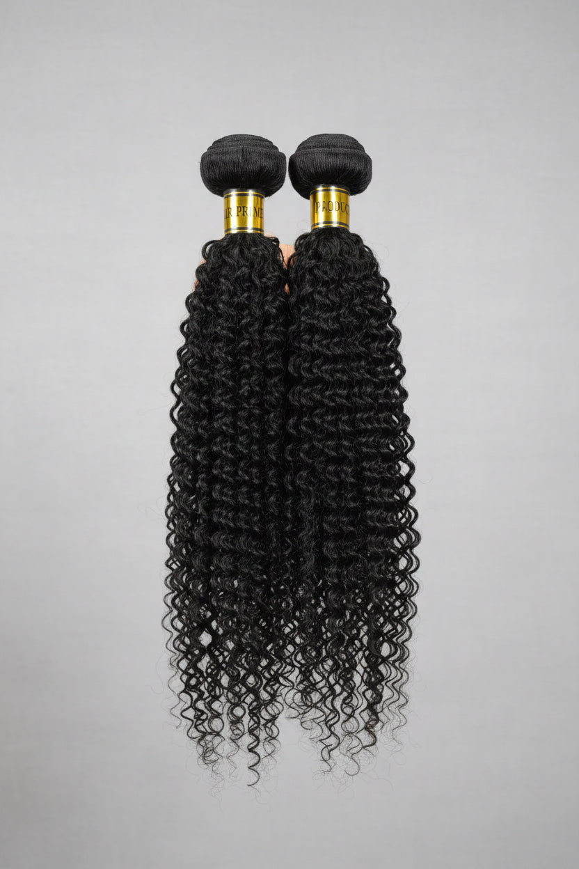 Two bundles of curly black hair extensions on a gray background